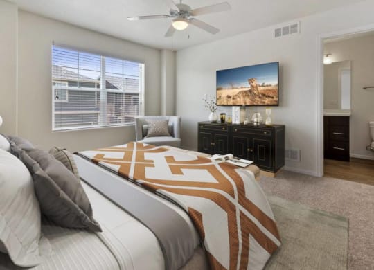 Bedroom With TV at Belle Creek Commons, Henderson, CO