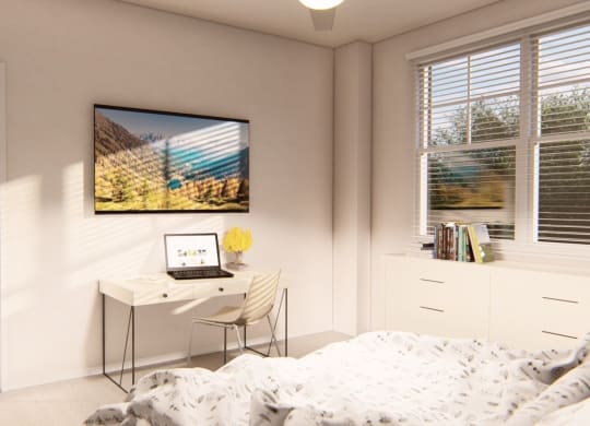 Spacious bedroom with a desk and laptop at Brownstones at Palisade Park, Broomfield