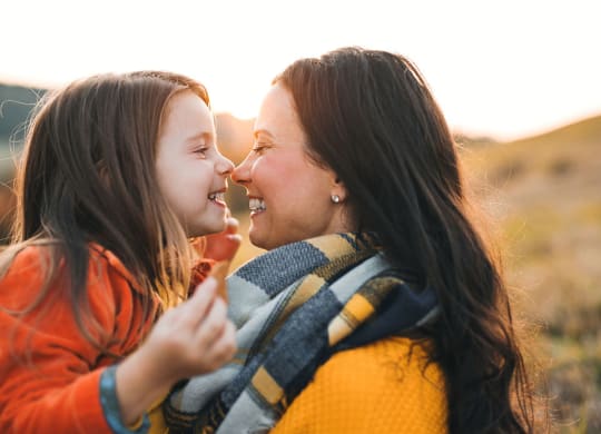 a mother and daughter smiling  at each other at Brownstones at Palisade Park,  Colorado, 80023