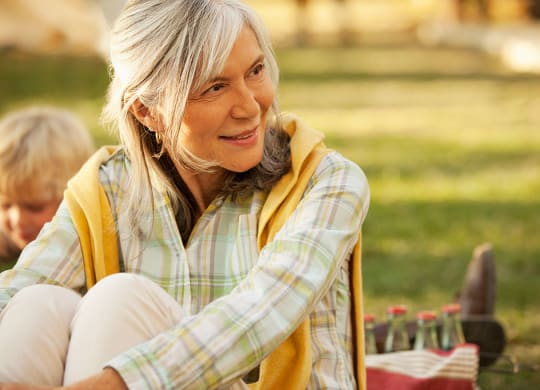 a woman sitting on the grass  at Brownstones at Palisade Park, Broomfield, CO,  80023