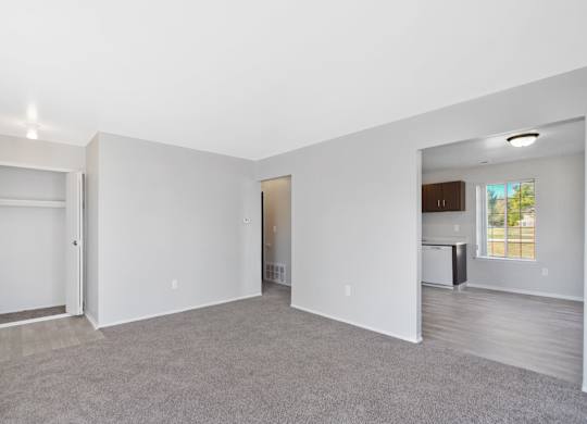 Open-concept living room with dining area and kitchen at Farmbrooke Manor Clinton Township MI