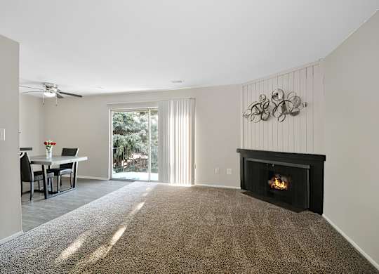 Open-concept living and dining area at Woodcrest Apartments in Westland, Michigan showcasing flexible floor space and contemporary design.