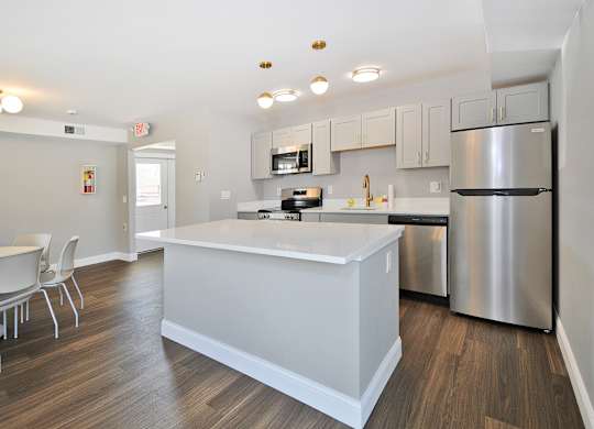Resident clubhouse with fully equipped stainless steel appliances kitchen Warren Woods Apartments in Warren, MI.