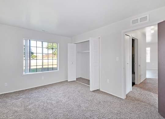 Comfortable bedroom with ample closet space at Farmbrooke Manor Apartments Clinton Township MI