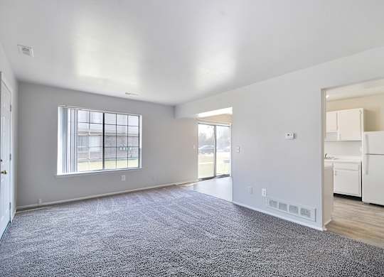 Open-concept living room with dining area and kitchen at Farmbrooke Manor Clinton Township MI