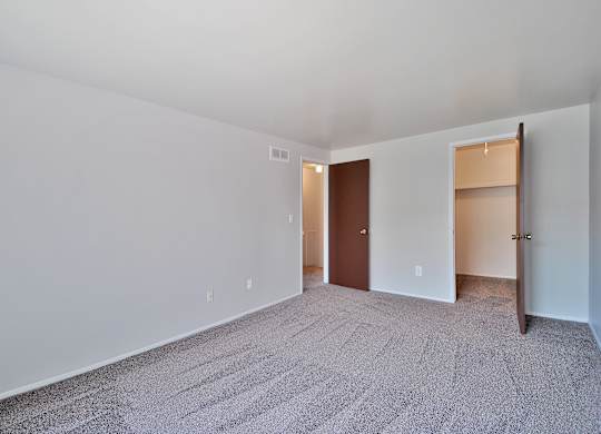 Comfortable bedroom with ample closet space at Farmbrooke Manor Apartments Clinton Township MI