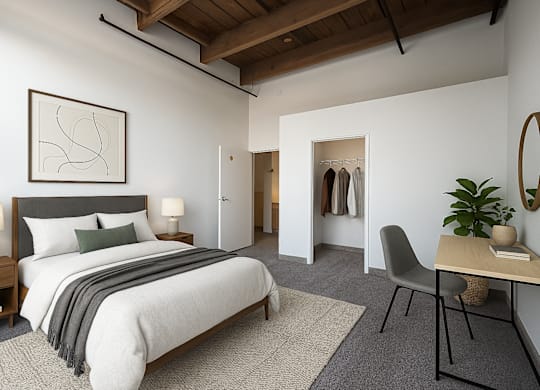 A bedroom with a large bed and a chair.