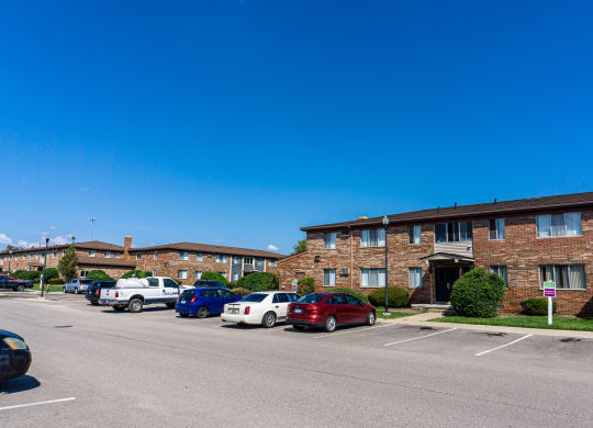 Exterior of apartment and ample parking space at Golf Manor Apartments in Roseville, Michigan