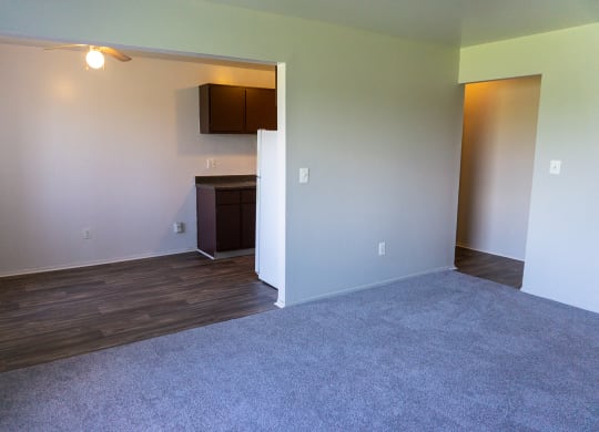 Spacious living room and dining room at Golf Manor Apartments in Roseville, Michigan