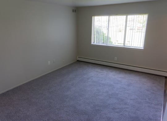 Spacious living room at Golf Manor Apartments in Roseville, Michigan