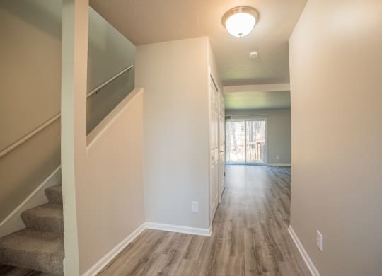 Spacious layout, stairs, and newly renovated wood floors at Westwind Townhomes in Lansing, Michigan