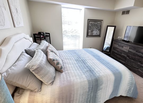 a bedroom with a large bed and a tv