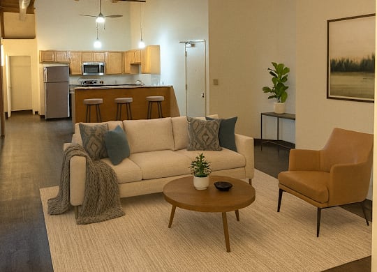 A living room with a white couch, a wooden coffee table, and a brown chair.