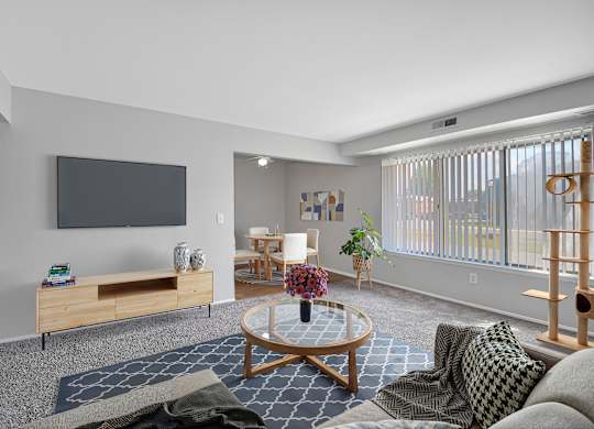 A living room with a flat screen TV mounted on the wall.
