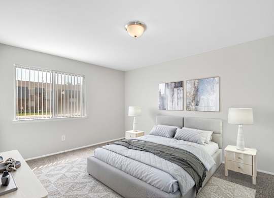 A bedroom with a large bed and two lamps.