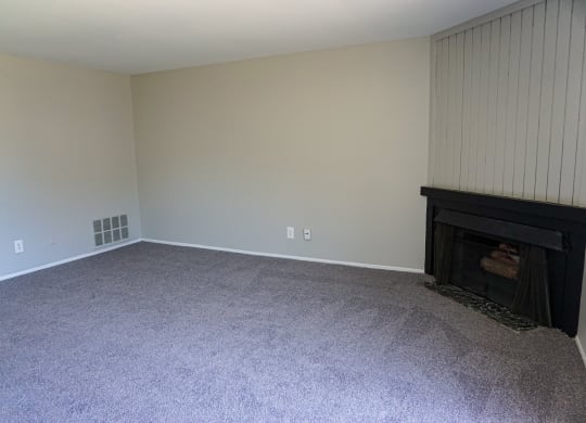 Fireplace and spacious living room at Woodcrest Apartments in Westland, Michigan