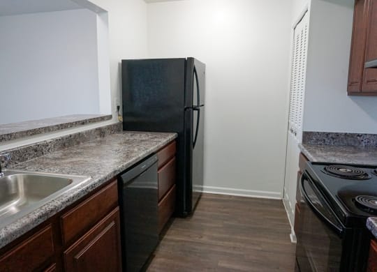 Fully Equipped Kitchen with granite counter tops at Woodcrest Apartments in Westland, Michigan