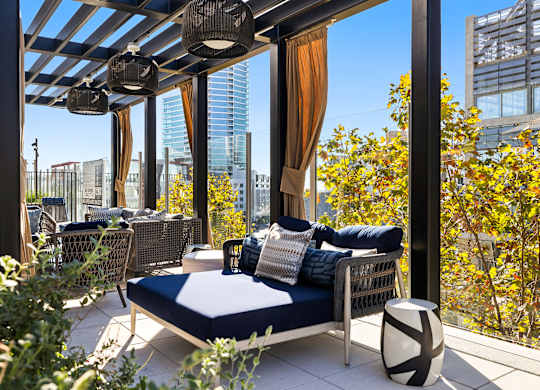 Patio with a couch and a table at K1 Apartments, California