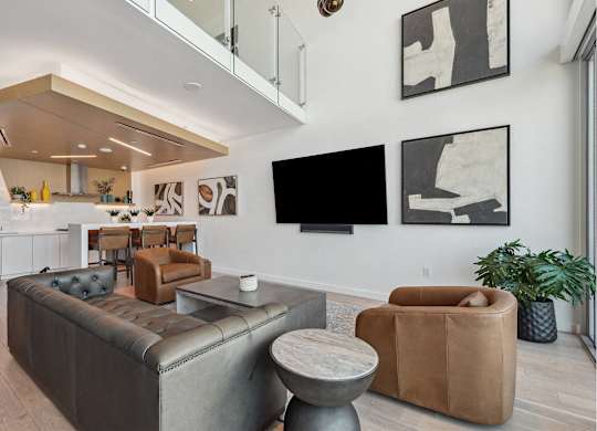 Living room with grey couch at K1 Apartments, San Diego, California
