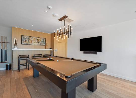 Pool table in a living room at K1 Apartments, San Diego