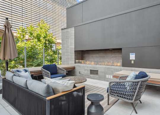 Living room with couches and chairs and a fireplace at K1 Apartments, California