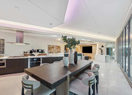 Large dining room with a long table and chairs at K1 Apartments, California, 92101