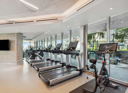 Gym with cardio machines and a television at K1 Apartments, San Diego, 92101