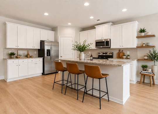 Spacious kitchen with an island, ample storage, and stainless steel appliances.