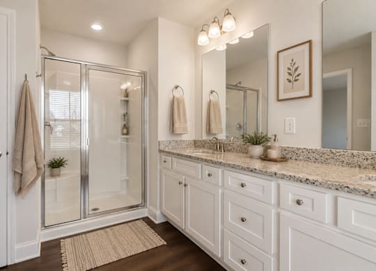Primary Suite featuring a walk in shower.