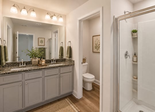 Primary Suite featuring a walk in shower.