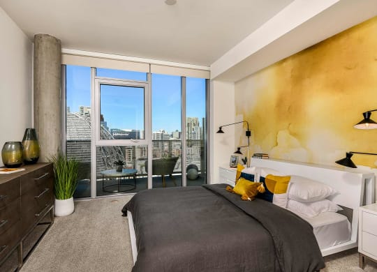 Master bedroom with large windows at K1 Apartments, San Diego, CA