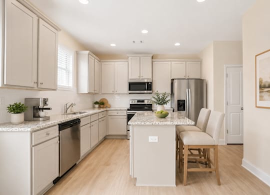 A kitchen with white cabinets and appliances.
