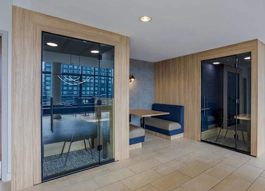 A modern room with a glass door and a bench.