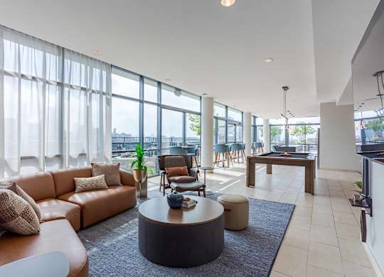 A living room with a brown sofa and a coffee table.
