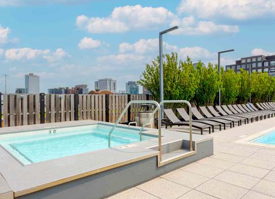 A pool with a view of the city in the background.