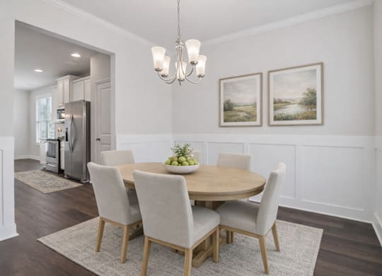 Elegant dining room featuring a rich wooden table and timeless seating—designed for unforgettable family gatherings.