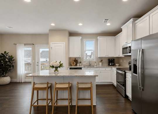 A kitchen with a white countertop and stainless steel appliances.