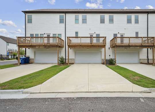 A two-story apartment building with a balcony on each floor.