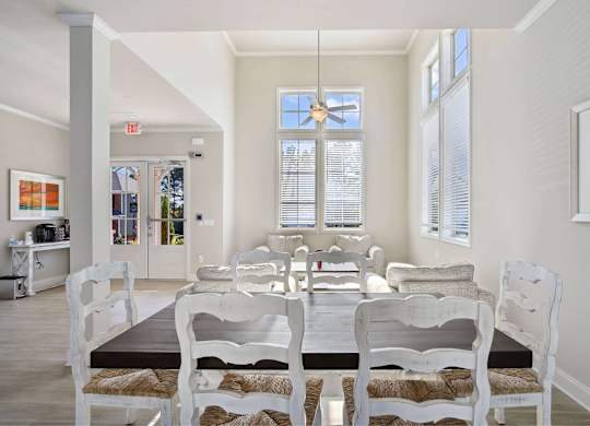 A dining room with a table and chairs.
