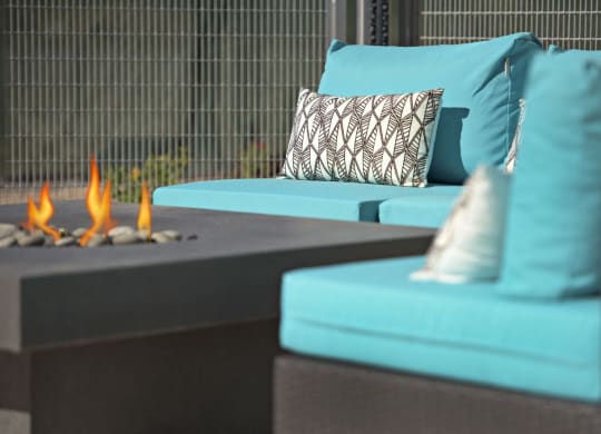 a living room with blue couches and a fire pit at Novella Arcadia, Phoenix, AZ 85018