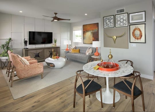 a living room with a table and a couch and a tv at Novella Arcadia, Phoenix
