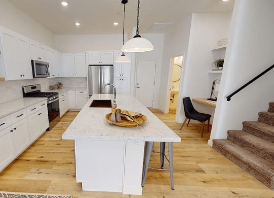 a large white kitchen with a marble counter top at Novella Biltmore, Phoenix, AZ