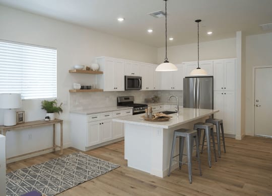 a kitchen with a center island and a counter top at Novella Biltmore, Phoenix, AZ 85016