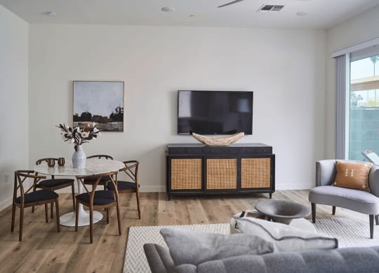 a living room with a couch and a table and a television at Novella Biltmore, Arizona, 85016