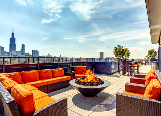 Resident rooftop lounge with a fire pit and skyline views of the Chicago at The Madison at Racine West Loop, Chicago, IL, 60607