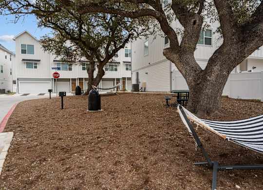 Courtyard with hammocks and benches at Villae ATX Luxury Rental Townhomes, Manchaca, TX