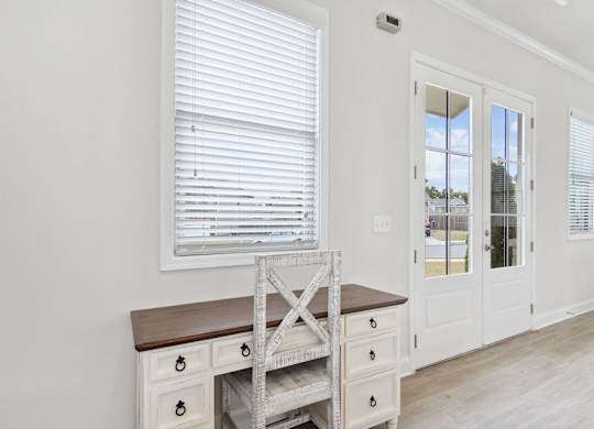Bright workspace featuring a white desk with built-in drawers