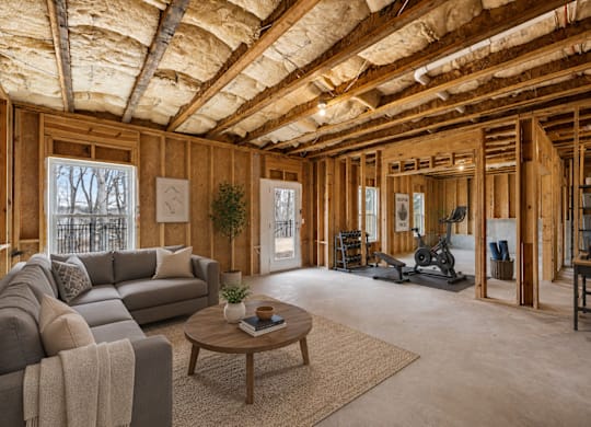 Expansive basement space offering endless possibilities, complete with a fitness area, comfortable living space, and ample storage.