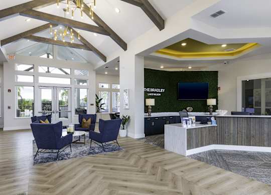 a lobby with a reception desk and chairs