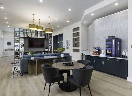 a living room with a table and chairs and a television